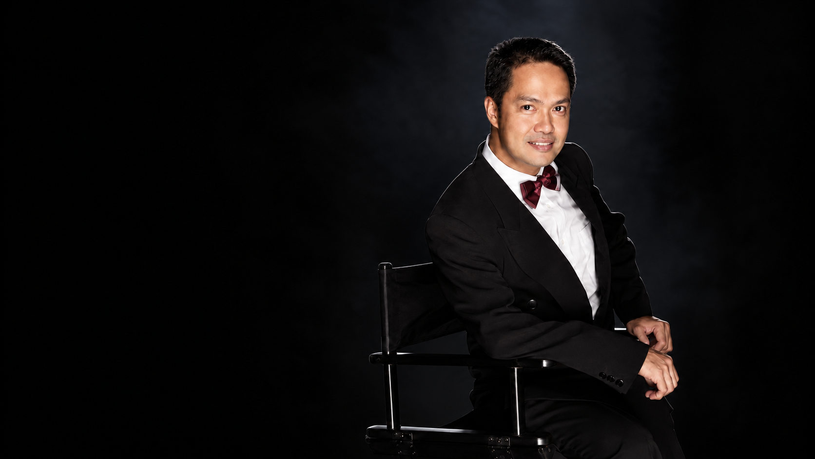 Director Dave Cecilio seated in a director's chair