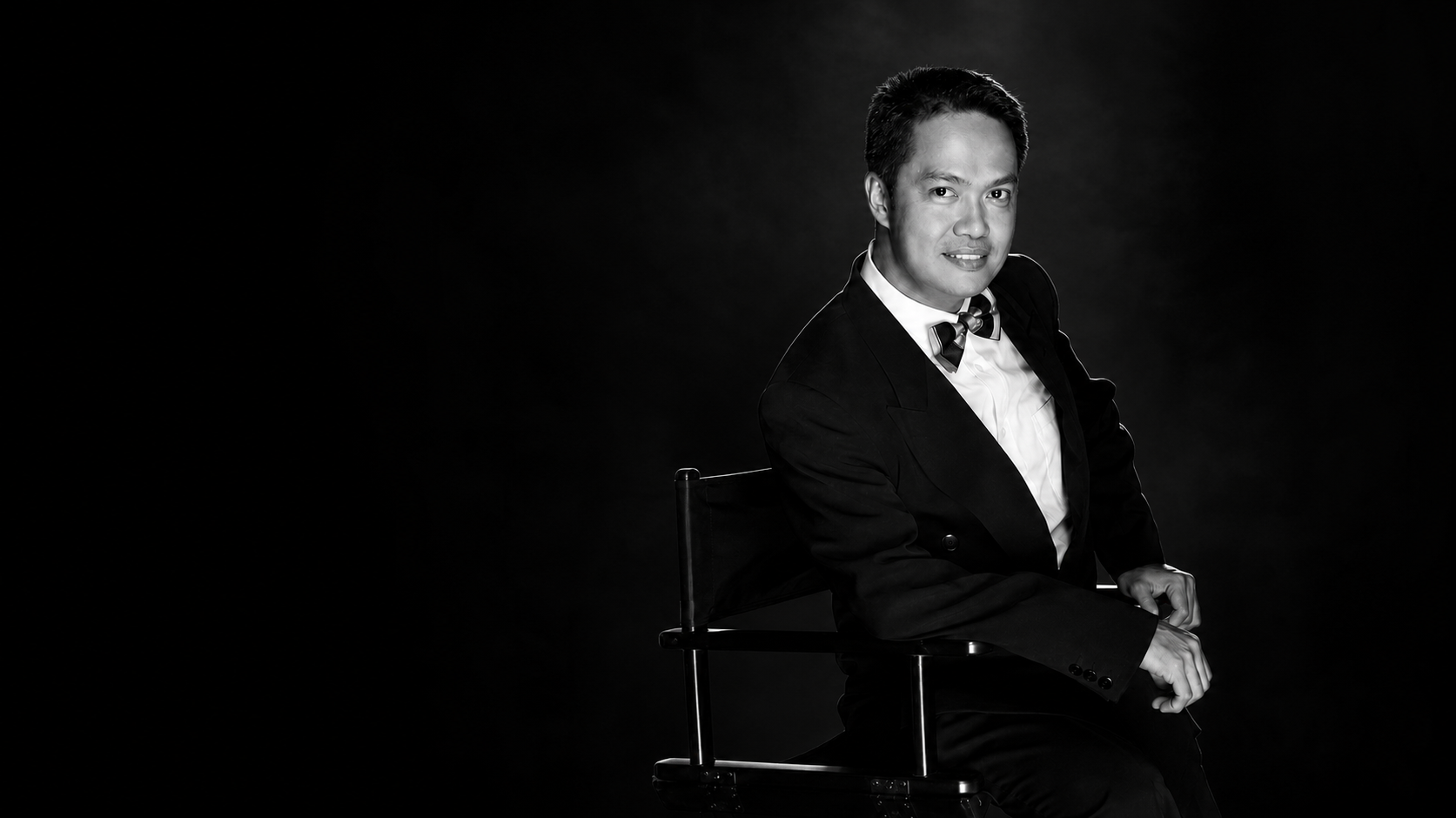 Director Dave Cecilio seated in a director's chair